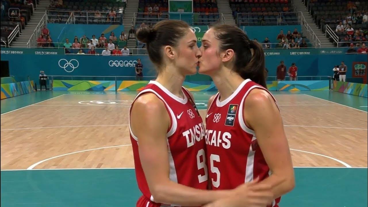 Golden Medal Kiss – Two Olympian Basketball Players Share a Victory Moment